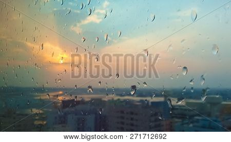 Evening Rain Drop In Glass With Sunset.