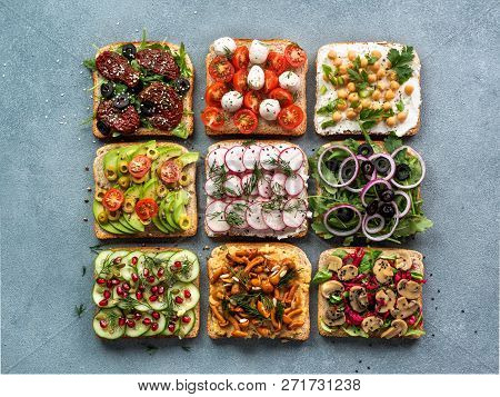 Assortment Vegan Sandwiches On Gray Stone Background. Set Different Vegetarian Smorrebrod. Top View 