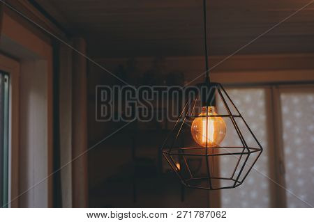 Edison Lamp In Vintage Style Lighting In Evening Home Interior. Earth Hour And Enegry Save Concept.