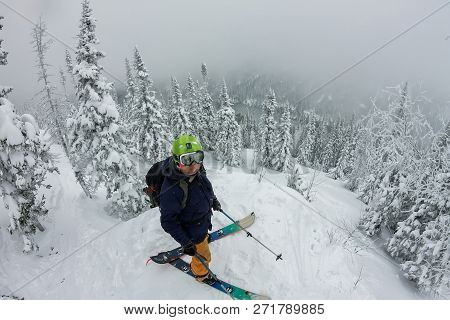 Man Splitboard Freerider Standing At Top Of Ridge. Ski Touring In Mountains, Winter Freeride Extreme