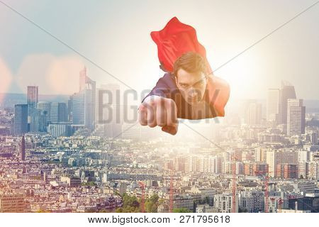 Superhero businessman flying over the city
