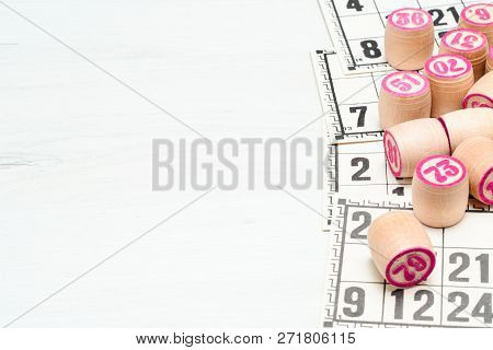 Board Game Lotto Or Bingo. Wooden Lotto Barrels With Numbers Lying On Lotto Cards, With Copy Space. 