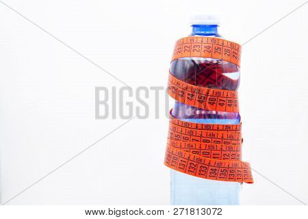 Bottle Of Water And Red Measure Tape