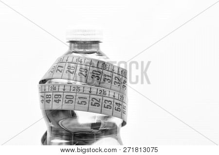 Bottle Of Water And Red Measure Tape