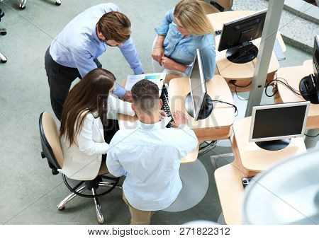 Top View Of Young Modern Colleagues In Smart Casual Wear Working Together While Spending Time In The