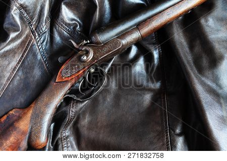 Ancient Hunting Shotgun Closeup On Leather Background