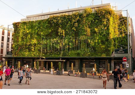 Avignon, France - July 22, 2011: Green Plants Living Facade Of Less Halles With Walking Around Peopl