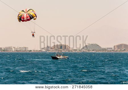 Eilat, Israel - May 15, 2012: Parasailing Is A Recreational Kiting Activity Where A Person Is Towed 