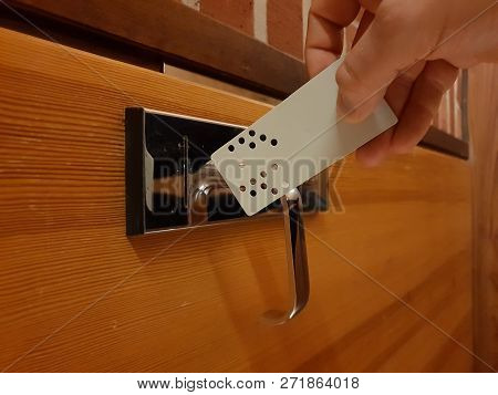 Image Of Analog Punchcard As A Key To Open Hotel Room Door