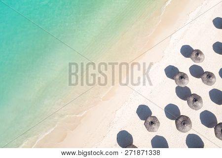 Aerial View Of Amazing Tropical White Sandy Beach With Palm Leaves Umbrellas And Turquoise Sea.