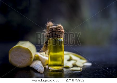 Close Up Of Essential Oil Of Bottle Gourd Or Dudhi Or  Calabash In A Transparent Glass Botlle On Woo