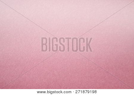 Pink Colored Construction Paper. Close up view of Colored Construction Paper. Backgrounds and Textures. Opacity filter used to lighten and grade the image.


