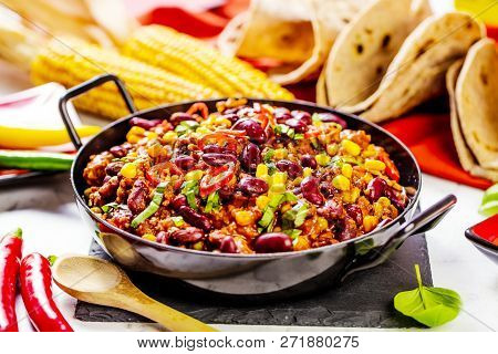Chili Con Carne In A Clay Bowl On A Concrete Or Stone Rustic Background- Traditional Dish Of Mexican
