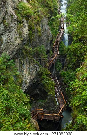 Hiking Along A Woodend Boardwalk In A Canyon Near Kaprun, Austria, Europe