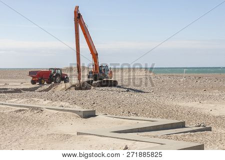 Excavator On The Beach In Norre Vorupor, Denmark, Europe.