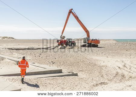 Excavator On The Beach In Norre Vorupor, Denmark, Europe.