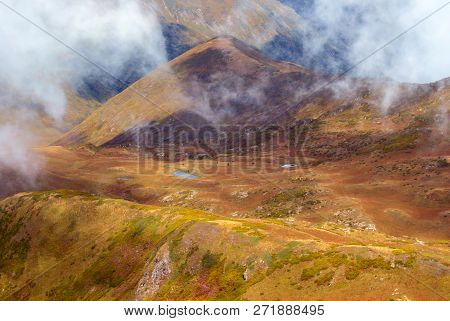Clouds-covered High Mountain Valley With A Lake, Aerial View