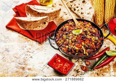 Chili Con Carne In A Clay Bowl On A Concrete Or Stone Rustic Background- Traditional Dish Of Mexican