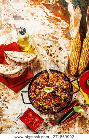 Chili Con Carne In A Clay Bowl On A Concrete Or Stone Rustic Background- Traditional Dish Of Mexican