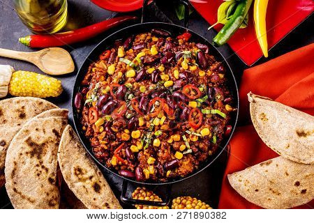 Chili Con Carne In A Clay Bowl On A Concrete Or Stone Rustic Background- Traditional Dish Of Mexican