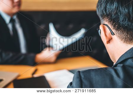 Senior Manager Reading A Resume During A Job Interview Employee Young Man Meeting Applicant And Recr
