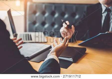 Senior Manager Reading A Resume During A Job Interview Employee Young Man Meeting Applicant And Recr