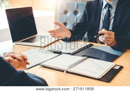 Senior Manager Reading A Resume During A Job Interview Employee Young Man Meeting Applicant And Recr