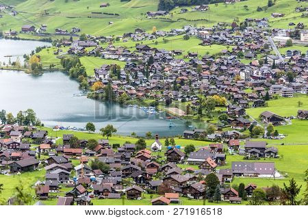 Amazing Dream Like Swiss Alpine Mountain Landscape, Wooden Chalets On Green Fields In Lungern Of Swi
