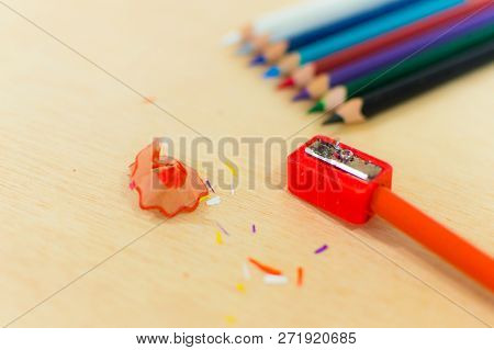 Aligned Colored Pencils On Top And Sharpener