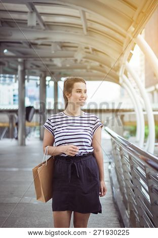 Portrait Of Happy Beautiful Woman Smling And Holding Shopping Bags In City,lifestyle Concept