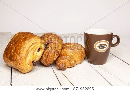 An Buttercake With Raisins And Croissant Is Made Of Puff Pastry