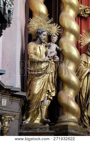 BRONNBACH, GERMANY - JULY 07, 2018: Saint Joseph holding baby Jesus, statue on the main altar in Cistercian Abbey of Bronbach in Reicholzheim near Wertheim, Germany