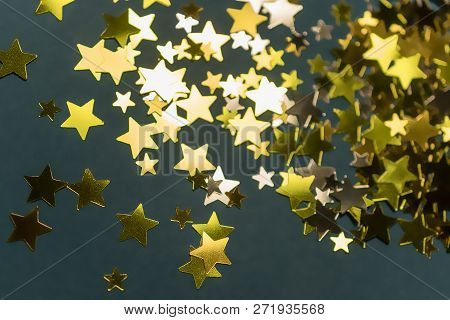 Golden Confetti Stars Scattered On The Surface.