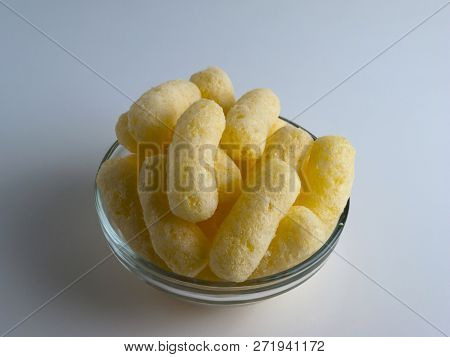 Corn Puffs In A Glass Bowl. Crunchy Flavored Puffed Snacks. Party, Movie Snacks.