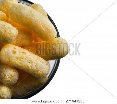 Corn Puffs In A Glass Bowl Isolated On White Background. Crunchy Flavored Puffed Snacks. Party, Movi