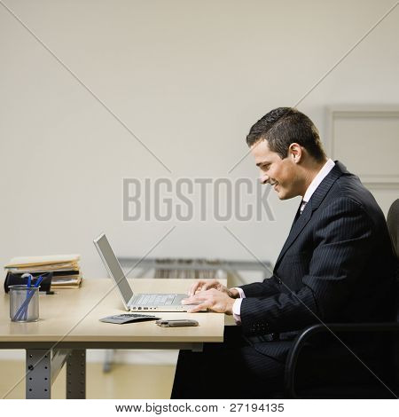 Obchodní muž pracuje na notebooku na stůl