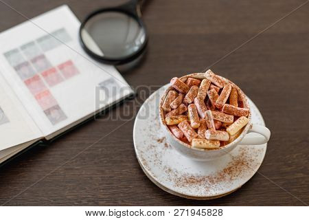 Passion For Collecting Stamps, A Hobby, An Album With Stamps, A Magnifying Glass, A Cup Of Coffee Wi
