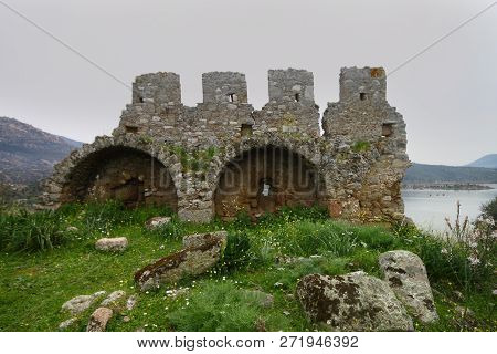 Ruined Walls Of Castle Over The Lake Bafa In A Nature Reserve Situated In Southwestern Turkey