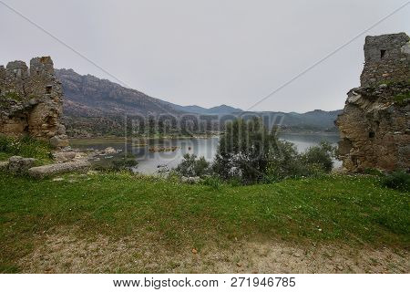 Ruined Walls Of Castle Over The Lake Bafa In A Nature Reserve Situated In Southwestern Turkey