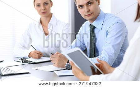 Group Of Business People Or Lawyers Discussing  Terms Of Transaction In Office. Colleagues Working A