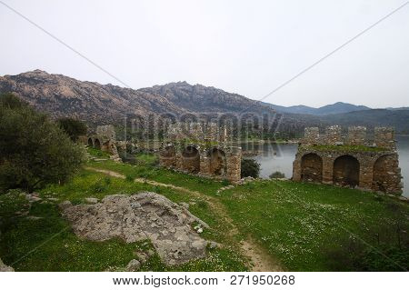 Ruined Walls Of Castle Over The Lake Bafa In A Nature Reserve Situated In Southwestern Turkey