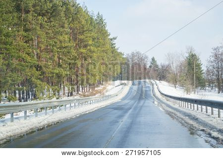Melting Snow Outside Of The City On The Country Road. Weather Forecast For Early Spring. Melting Sno