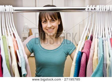 Curious teenager searching in closet for something to wear