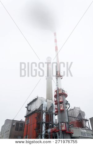 Old A New Chimneys At Heating Plant Covered In Fog, Cloudy Winter Day, Low Angle View, Energy Produc
