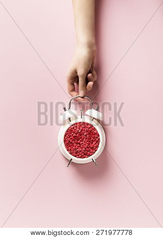 Valentines Day Concept Pastel Minimalis, Time To Gift, Alarm Clock And Hand On Pink Background