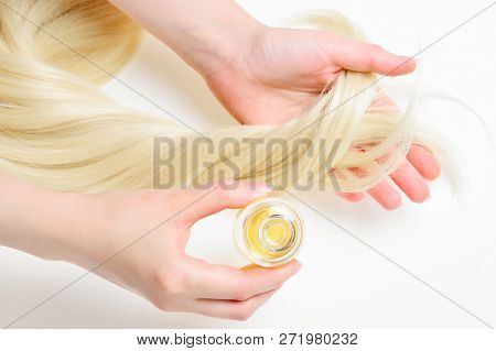 Oil Hair Treatment For Woman With Blond Hair On White Background. Spa, Beauty Salon. Hair Care In Mo