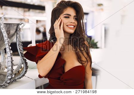 Smiling Young Girl With White Teeth And Big Lips, Looking Away. Stylis Makeup And Curly Long Hair. H
