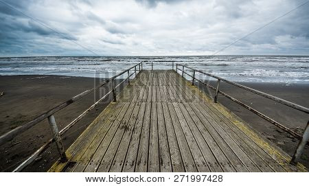 Rusty Bridge Stretching Into The Lifeless Sea, Caspian Sea Under Blue Sky In Early September, Snag O