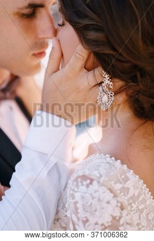 Close-up, The Wedding Couple Is Almost Kissing. The Groom Strokes The Brides Hand On The Cheek. Fine