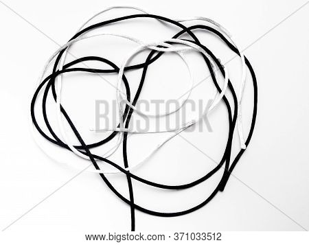 A Knot With A White Thread And A Black Thread Against A White Background